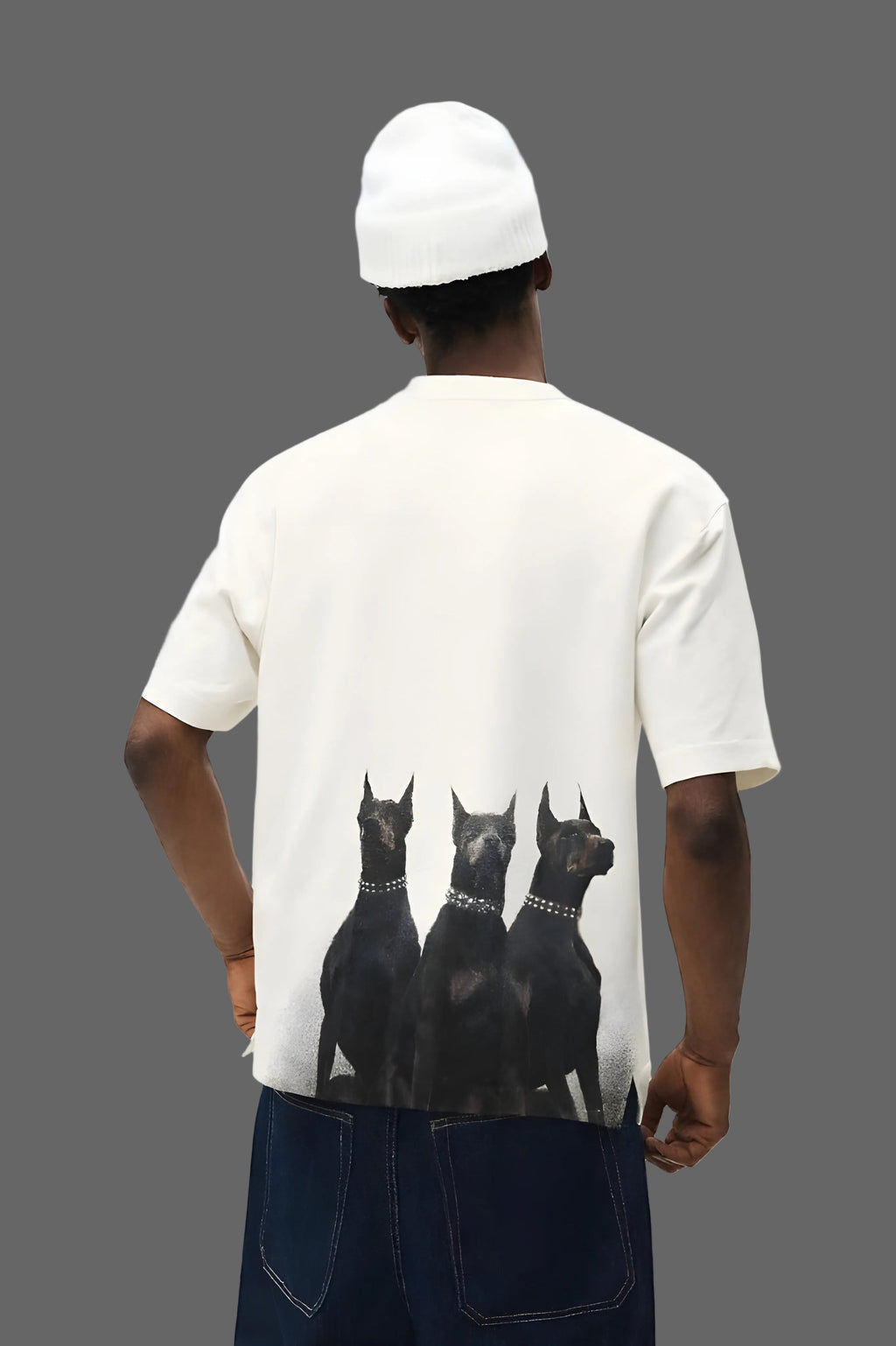 Person wearing a white t-shirt with black dog graphics on a plain background
