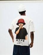 Person wearing a white t-shirt with a graphic design and text.