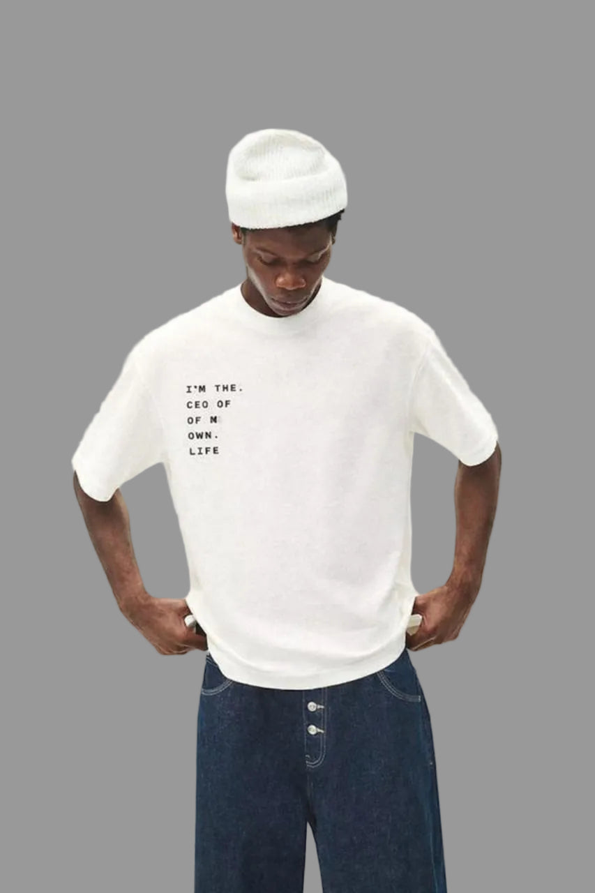 Person wearing a white t-shirt with text and blue jeans on a plain background, featuring the ASOS logo.