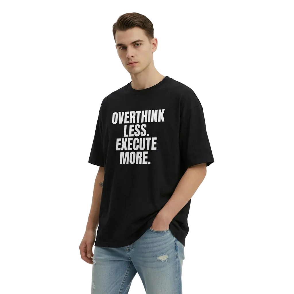 Man wearing a black t-shirt with motivational text on a plain background